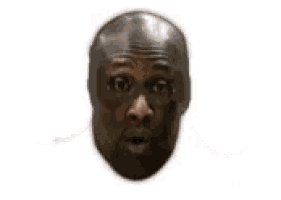 a bald man is holding a pair of sunglasses in front of his mouth .