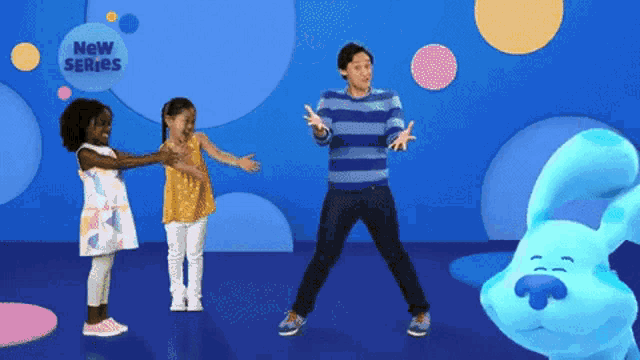 a man and two little girls are dancing in front of a blue bunny that says new series
