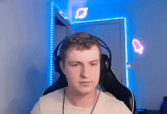 a man wearing headphones and a white shirt is sitting in a chair .