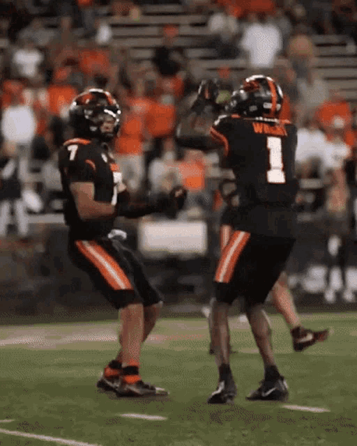 two football players one with the number 1 on his back
