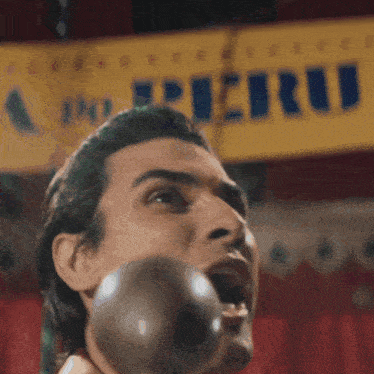 a man is blowing a bubble in front of a sign that says cirrus