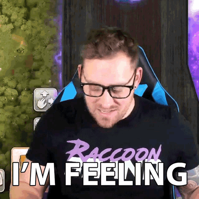 a man wearing glasses and a raccoon t-shirt is saying i 'm feeling