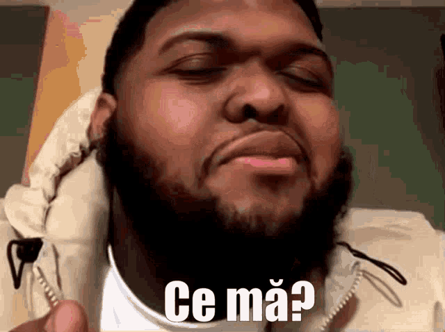 a man with a beard is making a funny face and says " ce ma "