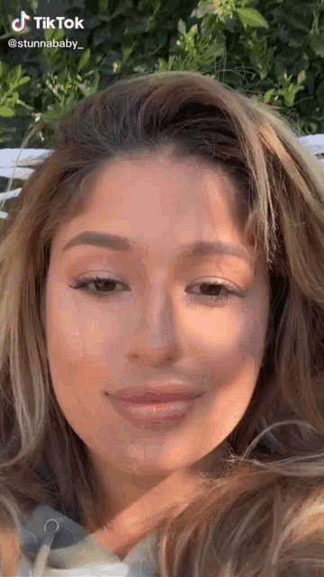 a close up of a woman 's face with a tik tok watermark