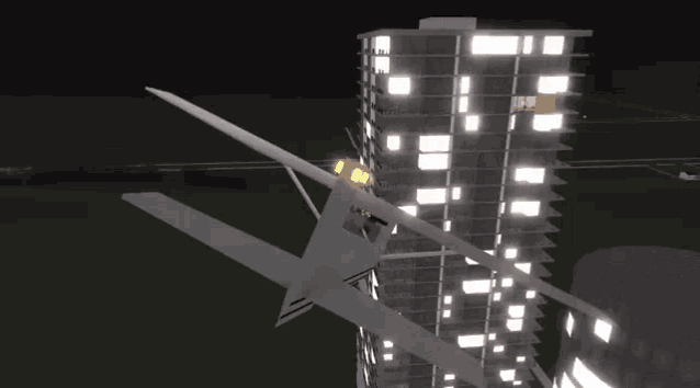 a plane is flying over a building at night with a flame coming out of the windows