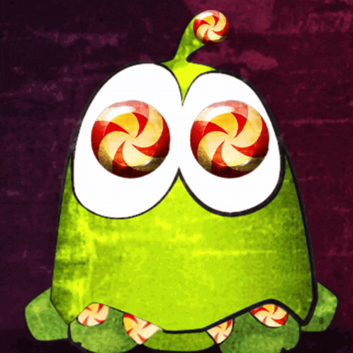 a green cartoon character with candy in its eyes