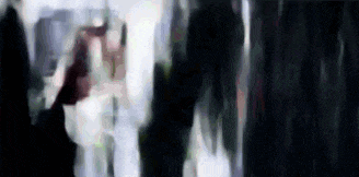 a blurry picture of a person standing in front of a window .