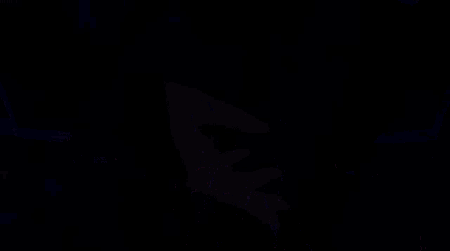 a cartoon character is standing in a dark room