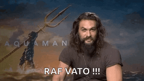 a man with long hair and a beard is holding a trident and making a peace sign .