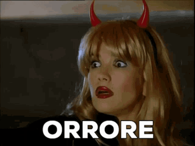 a woman in a devil costume is making a funny face and the word errore is behind her