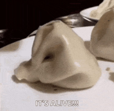 a close up of a dumpling with a hole in it on a table .