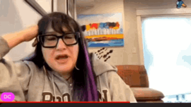 a woman wearing glasses and a hoodie that says dc