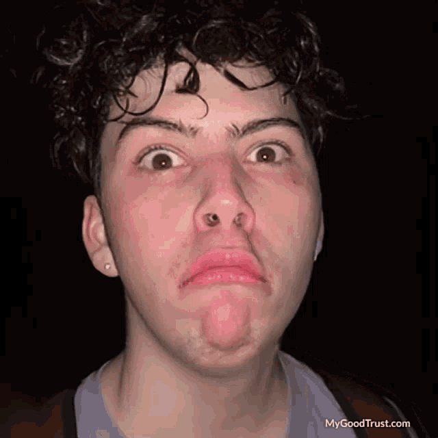 a young man making a funny face with mygoodtrust.com written on the bottom right