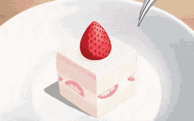 a piece of cake with a strawberry on top is being cut with a fork .