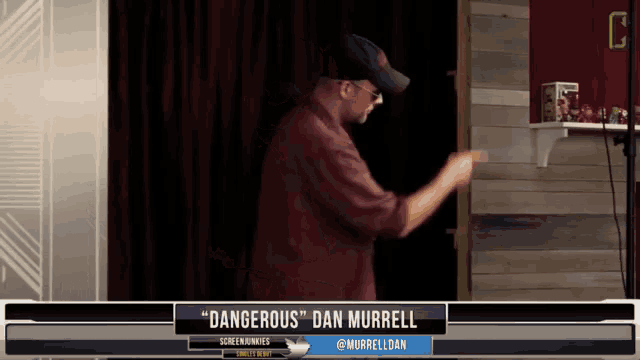 a man is dancing in front of a screen that says " dangerous " dan murrell