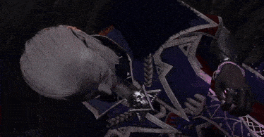 a man in a purple suit is laying down and smiling