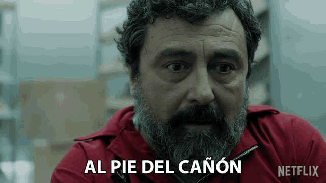 a man with a beard is wearing a red jacket with netflix written on it