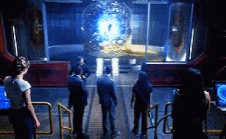 a group of people are standing in front of a large glass sphere