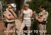 a group of police officers are standing next to a man in a tank top and shorts .