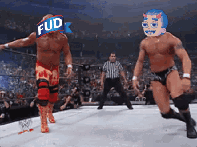 two wrestlers are standing on a wrestling ring and one has a sign that says fud