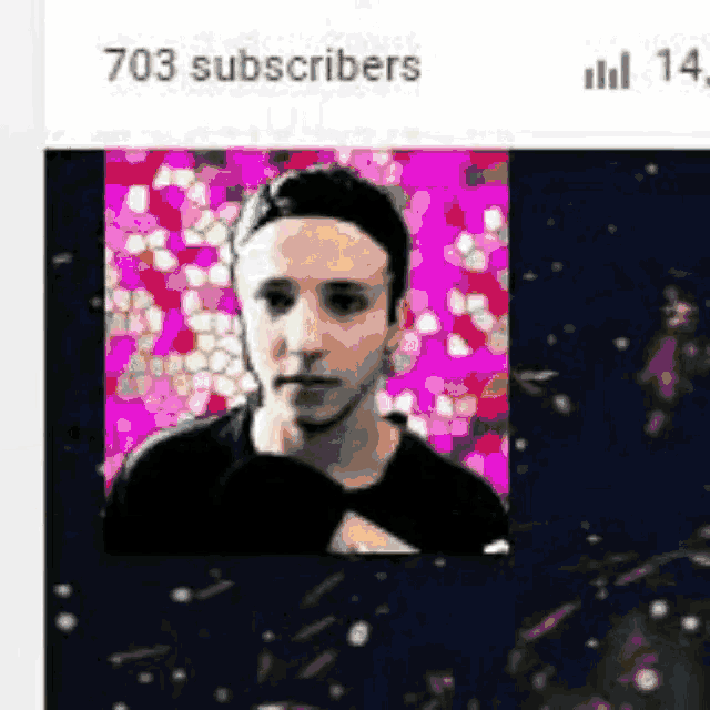 a man 's face is surrounded by pink and purple flowers .