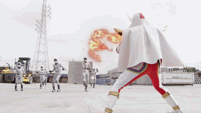 a man in a white cape and red pants stands in front of a group of ninjas