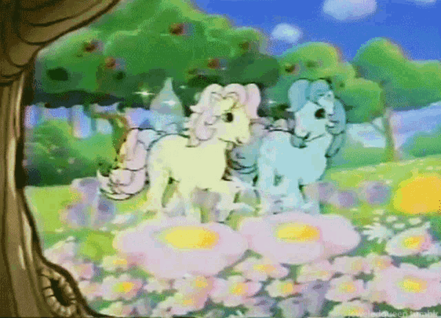 two ponies are standing in a field of flowers