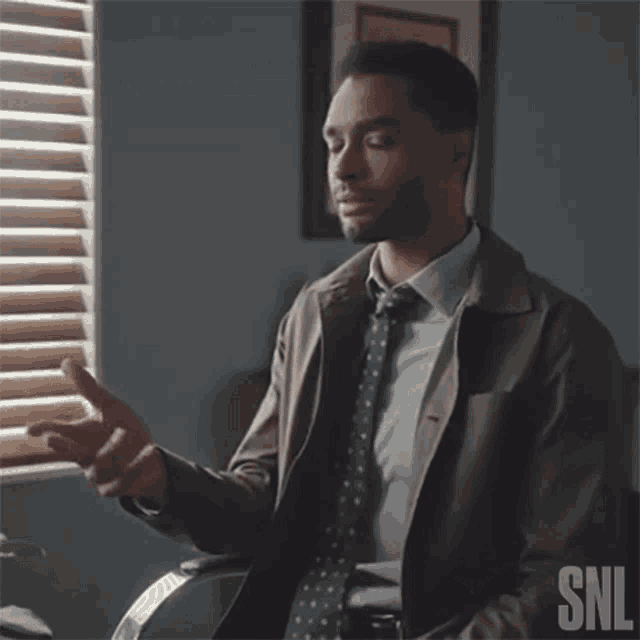 a man in a suit and tie is talking to someone