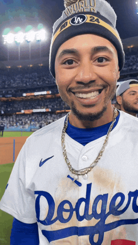 a man wearing a dodgers jersey and a world champions hat