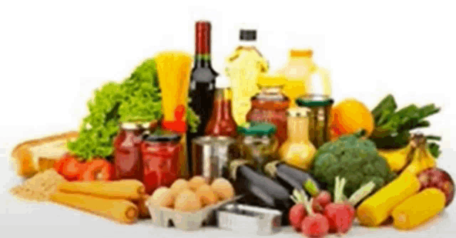 a table topped with a variety of vegetables , fruits , bottles , and other food items .