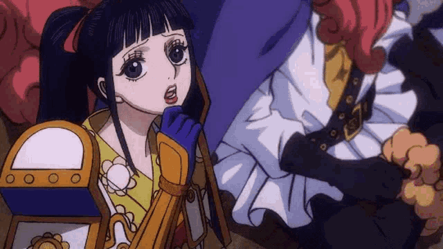 a girl in a kimono is sitting next to a man in a kimono .