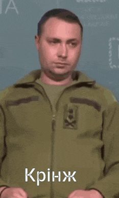 a man in a green jacket with a skull on it