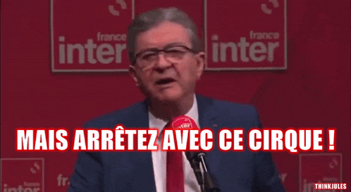 a man in a suit and tie speaking into a microphone with the words mais arretez avec ce cirque