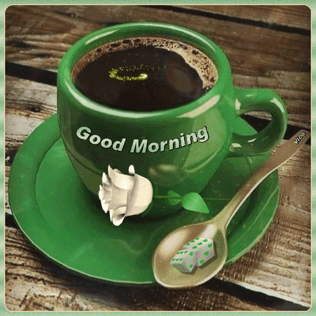 a green cup of coffee with the words good morning written on it