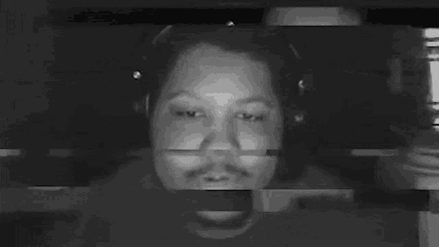 a black and white photo of a person covering their face .