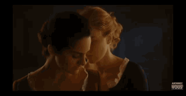 a couple of women standing next to each other with the word vous on the bottom right