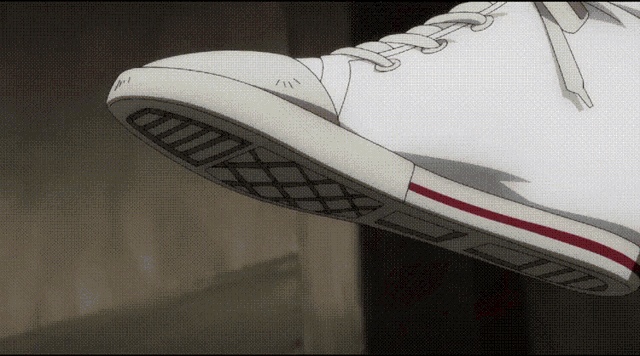 a person wearing a pair of white sneakers with a red stripe on the side