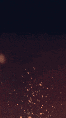 a dark background with a few spots of light coming out of it