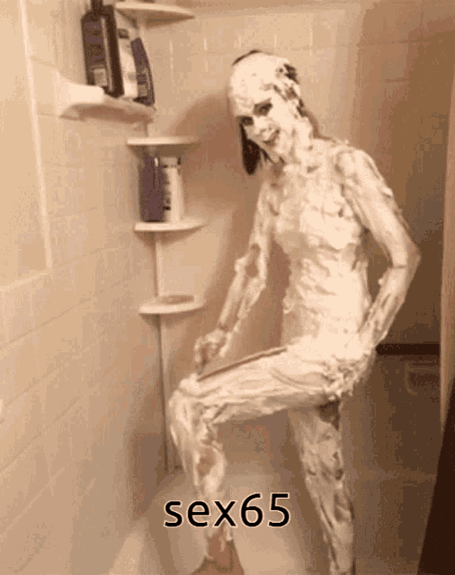 a woman covered in shaving cream is standing in a bathtub with the words sex65 above her