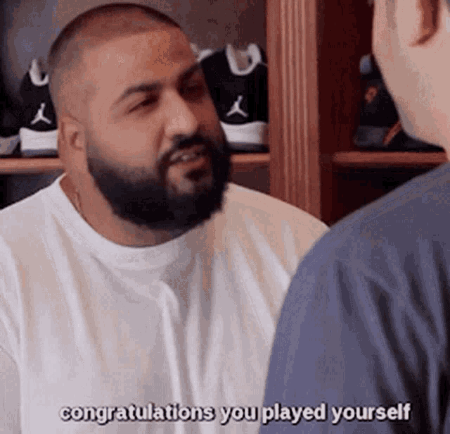 a man with a beard is talking to another man and says congratulations you played yourself