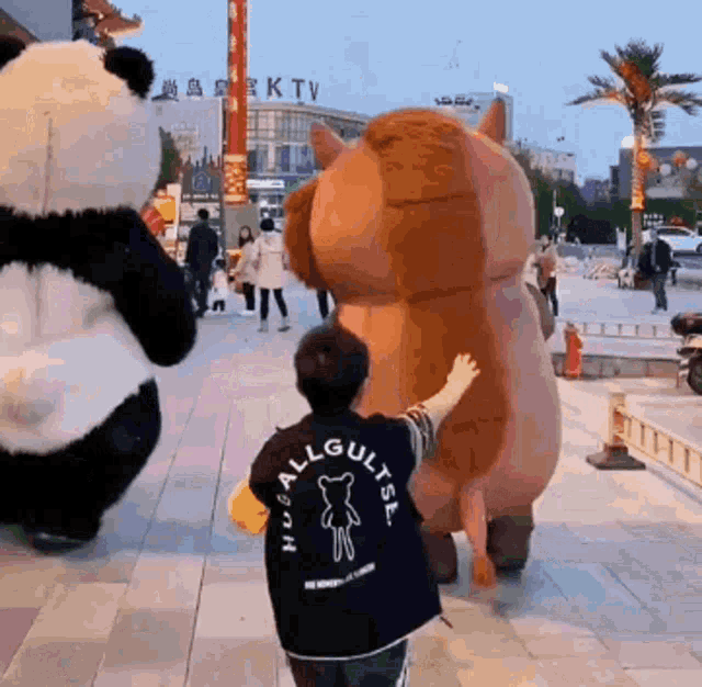 a person wearing a black shirt that says hua all gultsl on the back