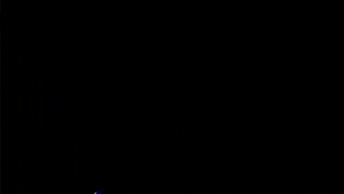 a blurry image of a person playing drums with a shirt that says u.n.e.