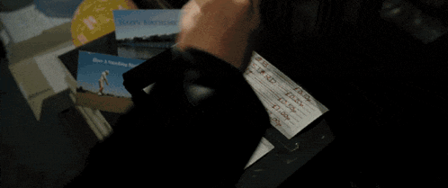 a person is writing on a piece of paper that says ' a ' on it