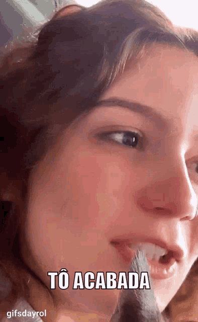 a close up of a woman 's face with the words to acabada above her mouth .