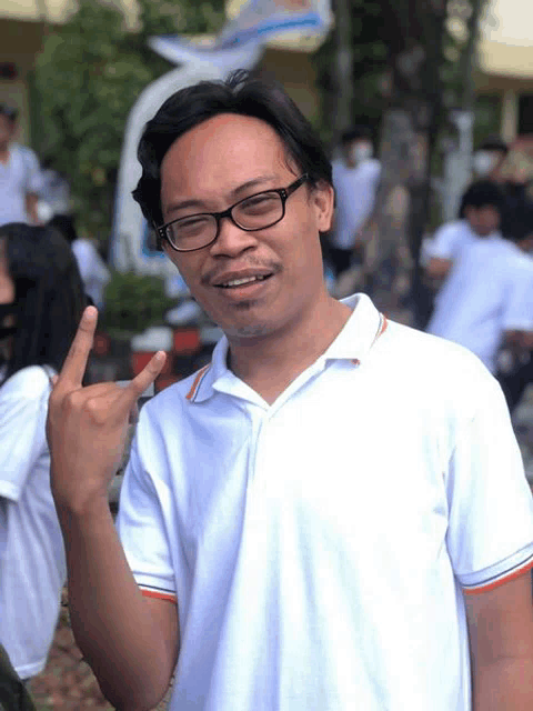 a man wearing glasses giving the middle finger