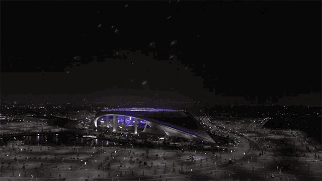 an aerial view of the los angeles rams stadium at night with purple lights