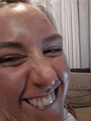 a close up of a woman 's face with a smile on it