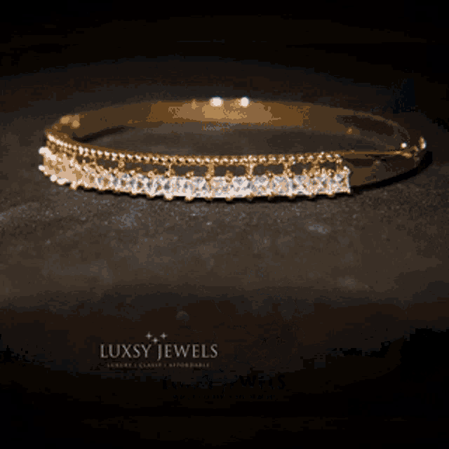 a luxsy jewels bracelet is sitting on a table