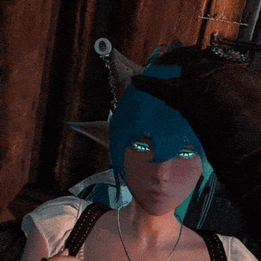 a woman with blue hair and green eyes is being touched by someone 's hand