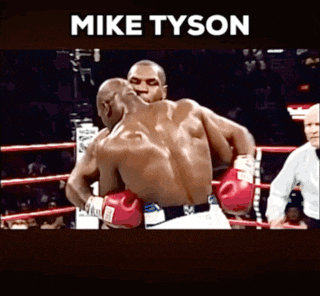 a picture of two men in a boxing ring with mike tyson written above them